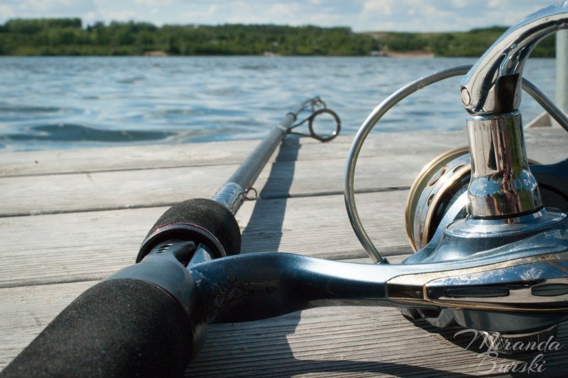 A fishing rod on the edge of a dock