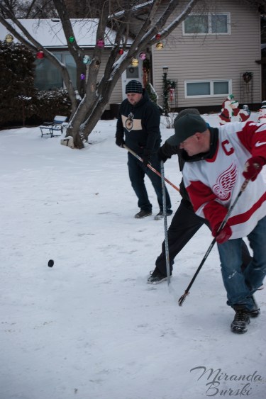 Three men lined up to get a puck