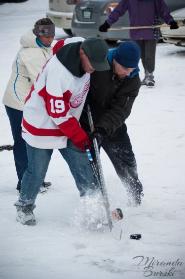 Two players fighting over a hockey puck