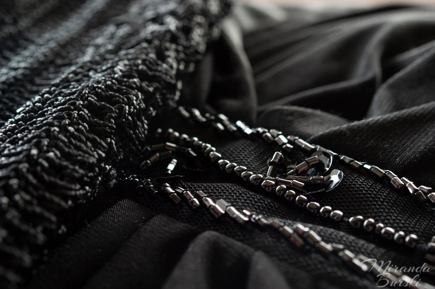Beads and sequins on a black dress and shawl.