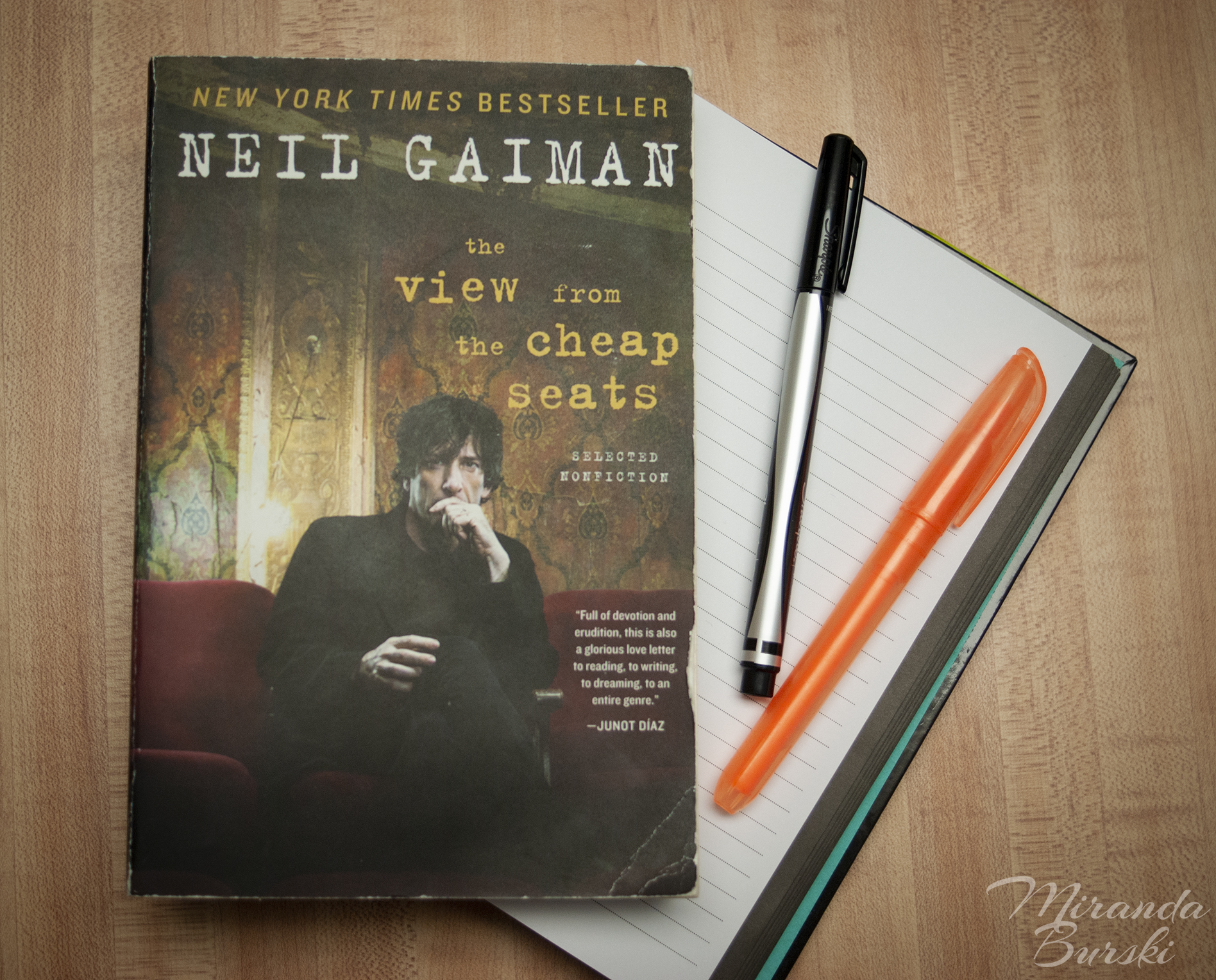 A copy of The View from the Cheap Seats, by Neil Gaiman, alongside a notebook, marker and highlighter.