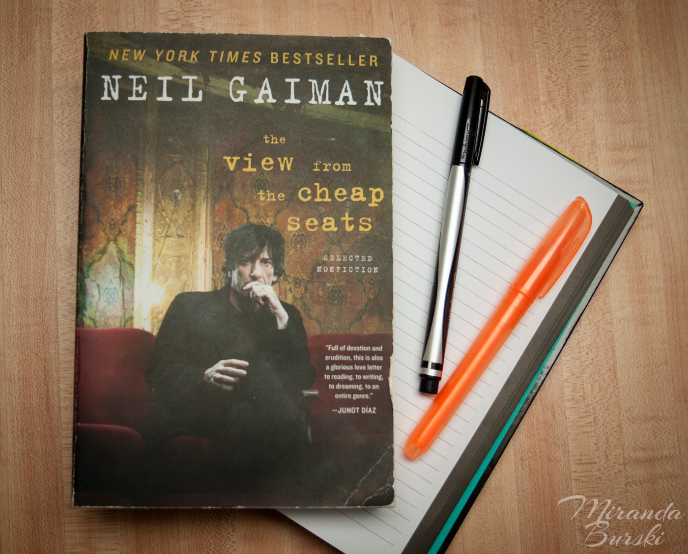 A copy of The View from the Cheap Seats, by Neil Gaiman, alongside a notebook, marker and highlighter.