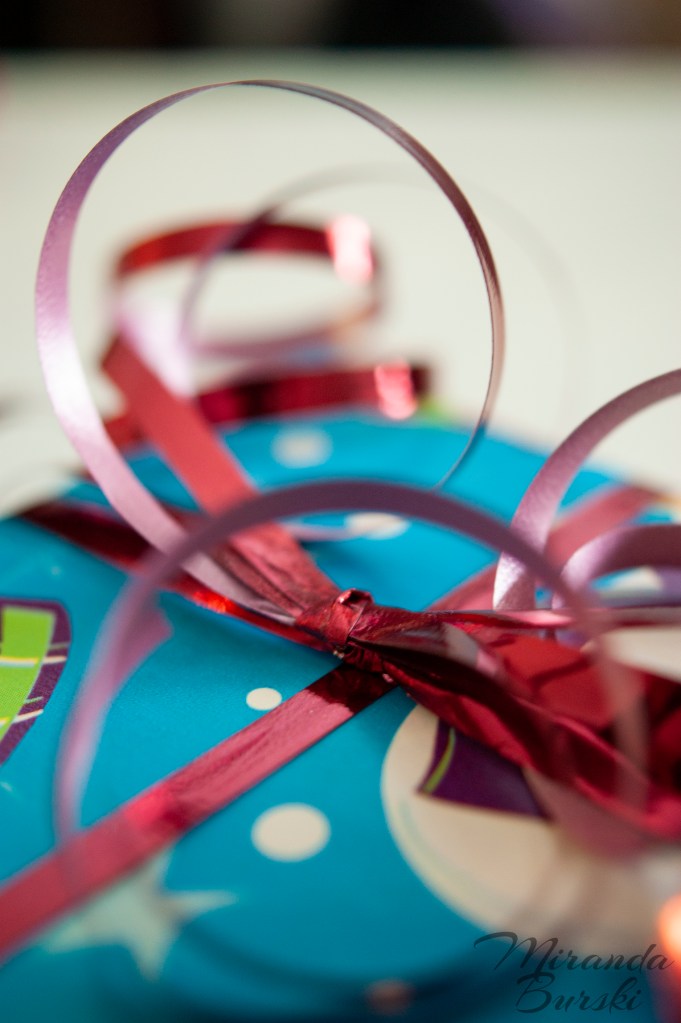 Curled red ribbon on a wrapped Christmas present