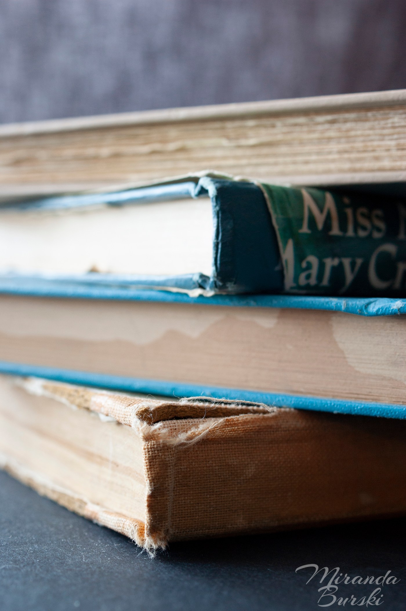 A pile of old, aged books.