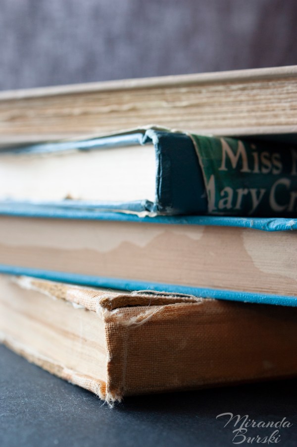 A pile of old, aged books.