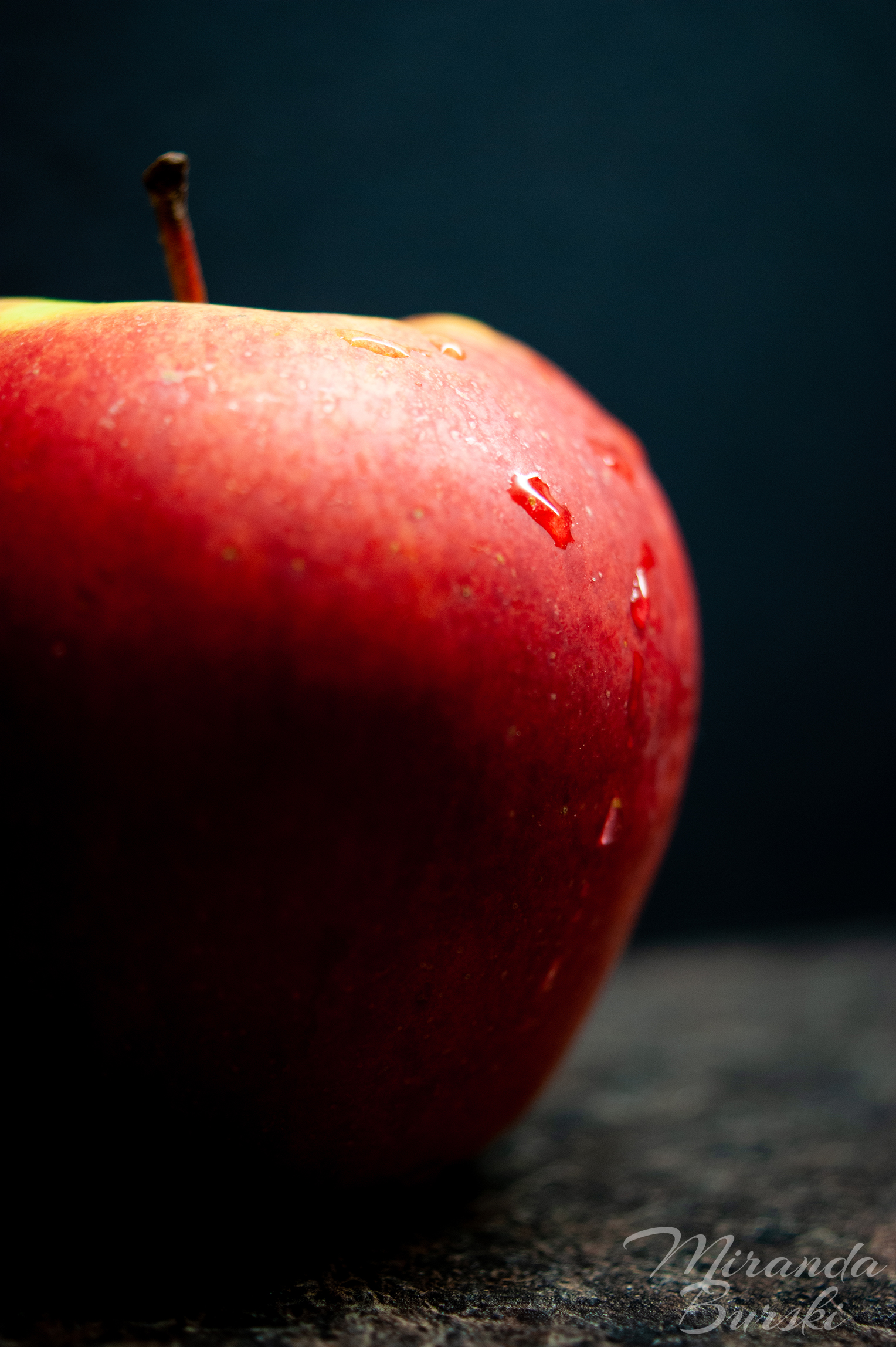 An apple on a black background.