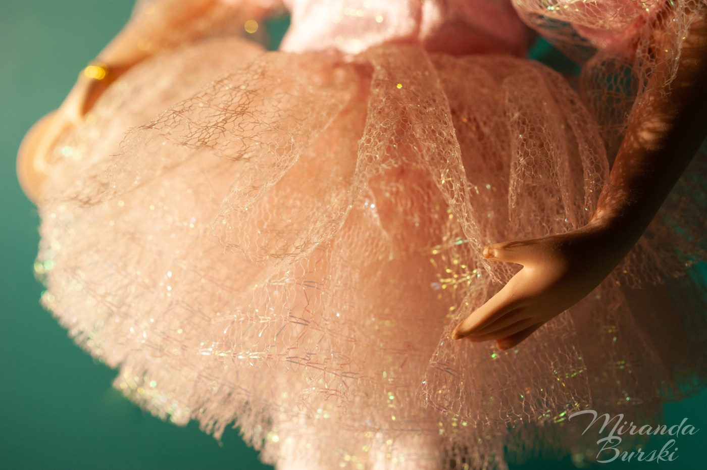A close-up of the skirt on a porcelain ballerina.