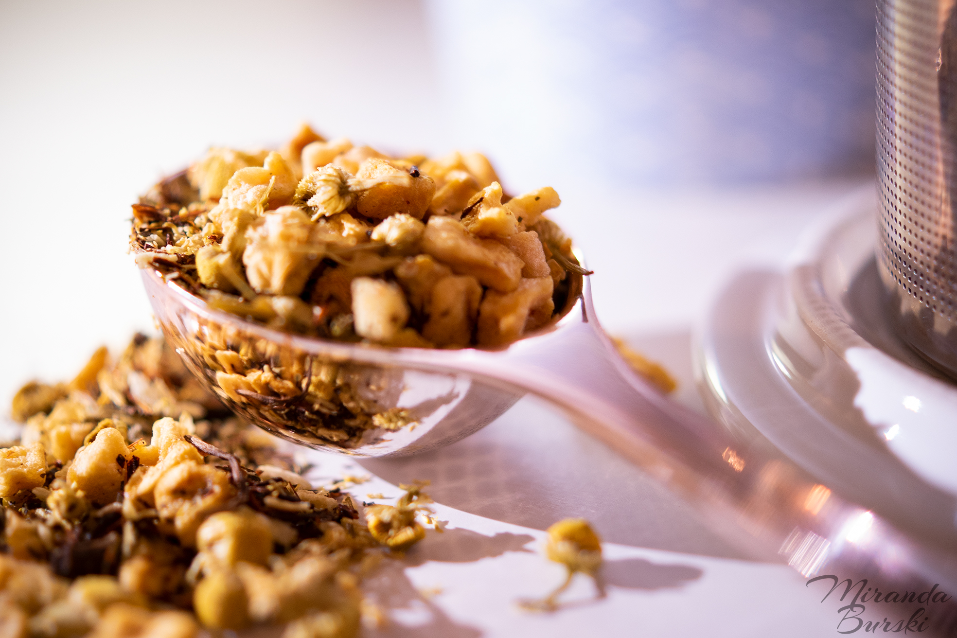 A close-up of a spoonful of loose-leaf tea.