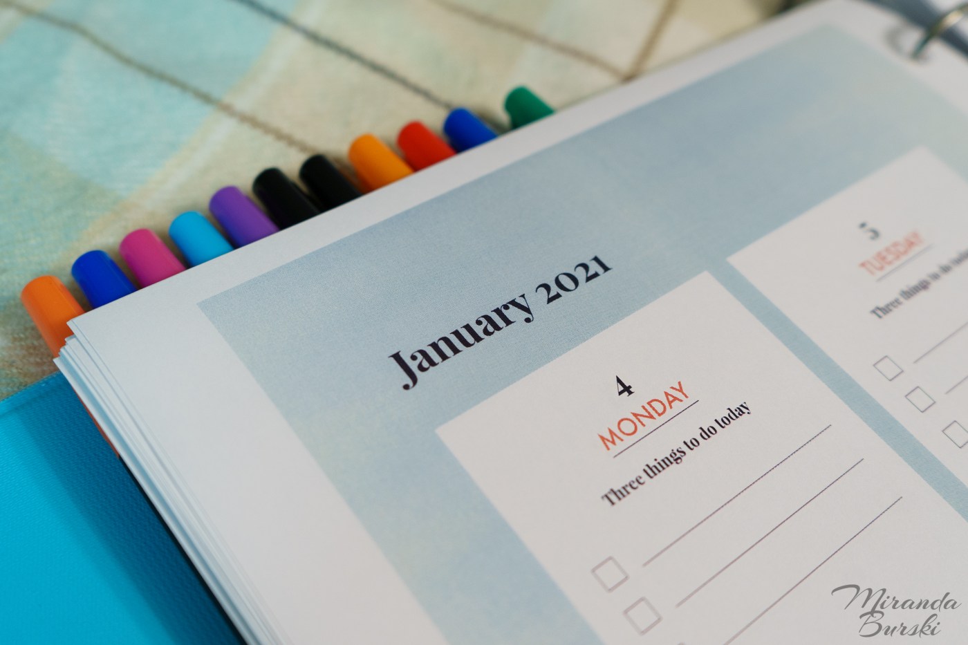 A 2021 planner, with markers sticking out of the top.